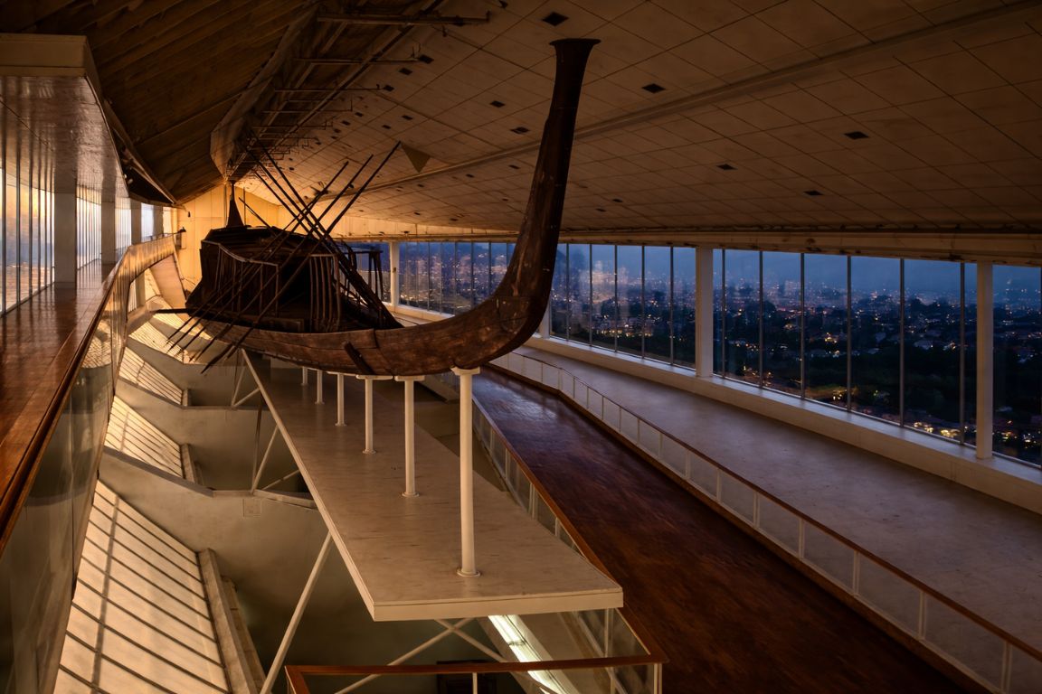 Khufu's reconstructed cedar solar boat displayed in its hall at the Grand Egyptian Museum