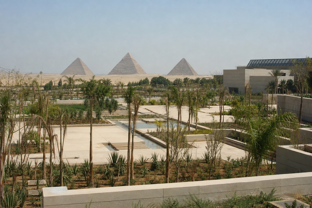 Landscaped gardens outside the Grand Egyptian Museum with the entrance beyond