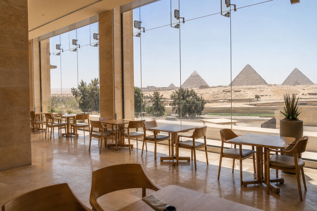 A cafe seating area inside the Grand Egyptian Museum with natural light