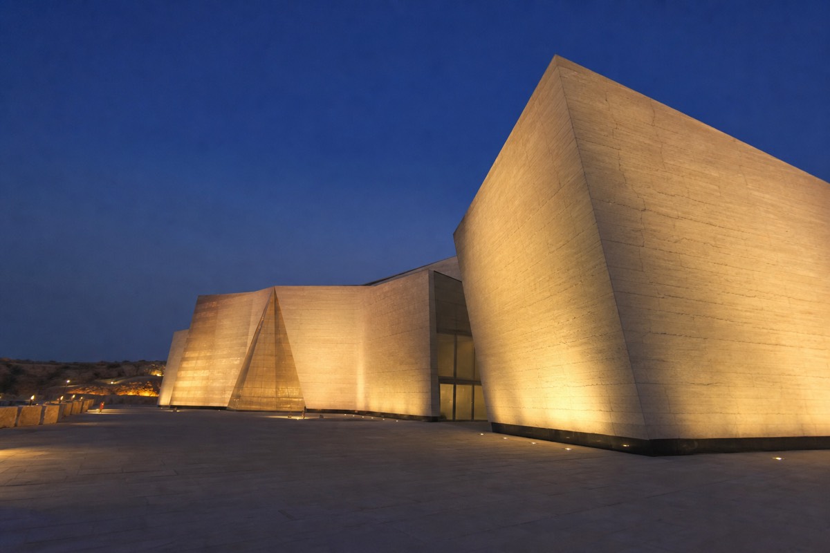 The Grand Egyptian Museum lit at dusk